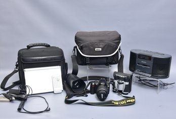 Nikon D360 Camera, Emerson Binoculars, Sony Dream Machine And Panasonic DVD-LA95 Portable Player