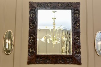 Ornately Carved Wooden Wall Mirror With Scrollwork Frame