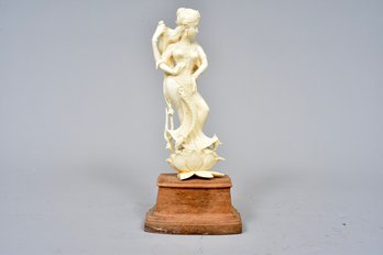 Carved Figurine On Wooden Stand