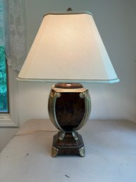 Classical Style Bronze Tone Finish Table Lamp With A Fabric Shade.