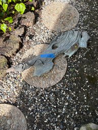 Stone And Metal Sculpture Of A Salamander On A Log