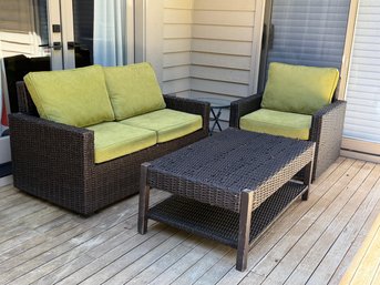 An Outdoor Patio Set With Love Seat, Chair & Coffee Table