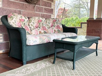 A Wicker Sofa And Glass Top Coffee Table By Lloyd Loom