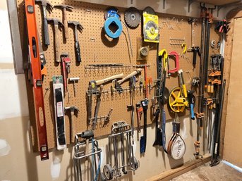 Huge Wall Of Tools Includng Many Clamps, Hammers, And More