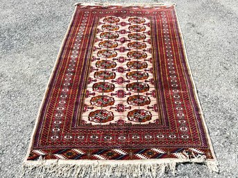 A Hand Knotted And Dyed Bokhara Rug