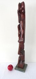 An Abstract Wooden Carved Totem Sculpture On Green Marble Base