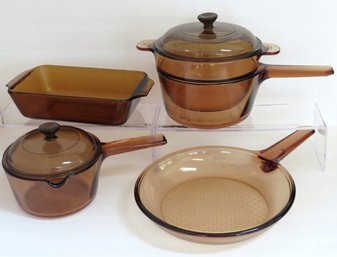 A 7 Piece Grouping Of Corning Vision  And Anchor Hocking Amber Color Glass Cookware