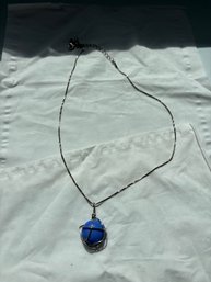 Silver Wire Cage Pendant Holding A Blue Sphere
