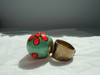 Unique Ceramic Or Enamel Ring Featuring A Green Orb With A Painted Orange Floral Pattern.
