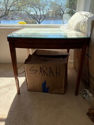 Vintage Wooden Accent Or Dining Table Featuring A Floral Embroidered Fabric Top And Glass Top