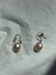 Pearl Earrings Featuring Lustrous Pearls Dangling From Sterling Silver Hooks