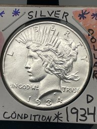 1934 -D Silver Peace Dollar. (9)