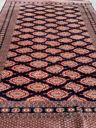 A Vintage Hand Knotted And Dyed Bokhara Area Rug