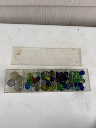 Assortment Of Colorful Glass Marbles And Larger Shooter Marbles