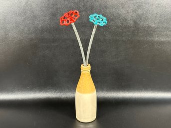 A Whimsical Art Piece: Spigot Handle Flowers In A Ceramic Bottle Vase