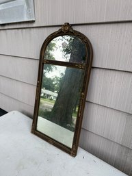 Arched Wall Mirror Featuring An Ornate Gilt Frame