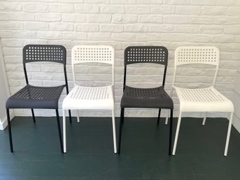 A Set Of Four Ikea ADDE Stacking Chairs