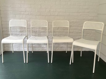 A Set Of Four White Ikea ADDE Stacking Chairs (set 1 Of 2)