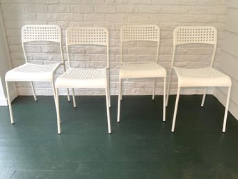 A Set Of Four White Ikea ADDE Stacking Chairs (set 2 Of 2)