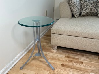 A Round Glass End Table With Metal Base