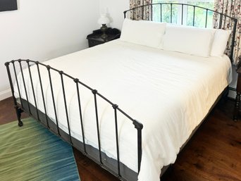 A Fine Quality Cast Iron King Bedstead With Linens From The Texture Collection, New York