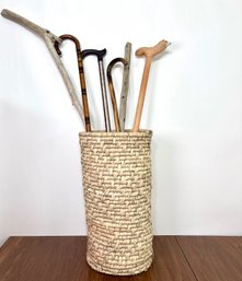 Walking Stick Group In Woven Basket