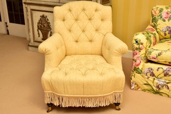 Custom Tufted Upholstered Arm Chair With Fringe Trim And Brass Casters