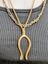 A Wishbone Pendent With A Cable Roll Or Textured Gold Plated Chain