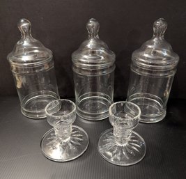 Assorted Glassware Lidded Jars And Candlestick Holders