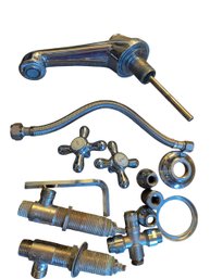 Various Plumbing Fixtures Including Washers, Faucet Head, And Faucet Handles