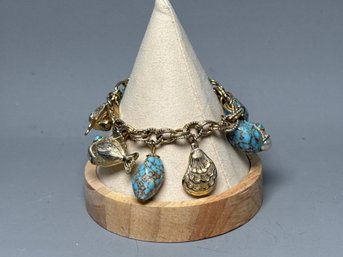 A Charm Bracelet With Turquoise Beads, Shells And Fish With Pearls