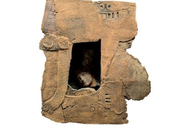 Unique Sculpture Featuring Faces Peering Out Of A Window