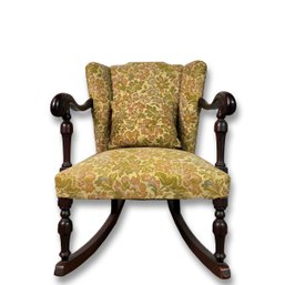Upholstered Mahogany Rocker With Carved Scrolled Arms