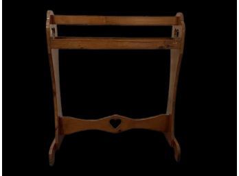 A Vintage Wooden Quilt Rack With Heart Design