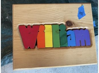 Footstool: Pine Puzzle With The Name William In Rainbow Colors.