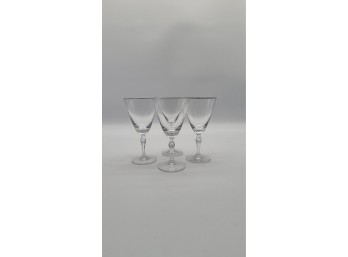 Four Silver-Tone Rimmed Glass Goblets With Faceted Stems