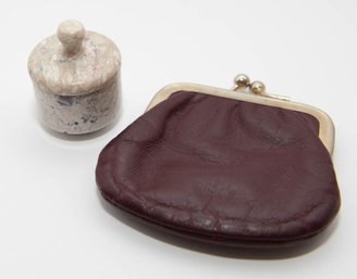 Vintage Burgundy Leather Coin Purse Sitting Next To A Hand-carved Marble Lidded Trinket Jar
