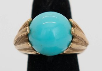 Vintage Avon Ring Features A Polished Blue Turquoise-colored Stone Set In Textured Gold-tone Metal