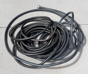 Black Commercial-grade Rubber Garden Hose, Designed For Heavy-duty Residential Or Professional Landscaping Use