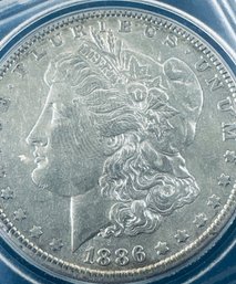 1886 MORGAN SILVER DOLLAR COIN- IN CAPSULE