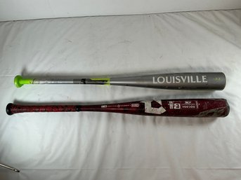 A Louisville Slugger Solo Baseball Bat And A Red And Black DeMarini Voodoo Baseball Bat