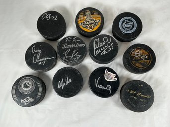 11 Hockey Pucks, Some Signed