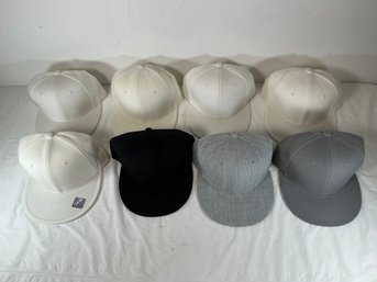 Eight Baseball Caps, One With City Hunter Sticker