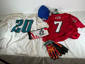 Sports Wear Lot Including White Jersey With A Teal '20,' A Red Reebok Michael Vick Atlanta Falcons Jersey