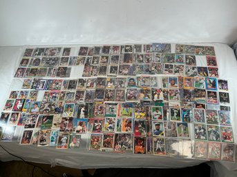 Baseball, Basketball, And Football Cards In Plastic Sleeves