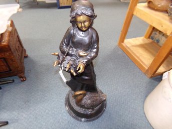 SIGNED E. PEYOT 2/10, HEAVY BRONZE SCULPTURE GIRL HOLDING GOSLINGS. ESTIMATE $650. TO $900.