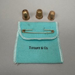 Three Gold Thimbles And A Tiffany & Co. Gold Safety Pin