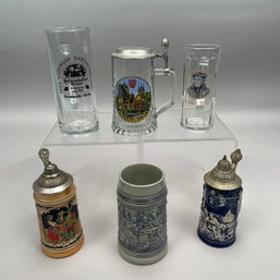 Three German Steins, One Glass Stein And Two Mugs
