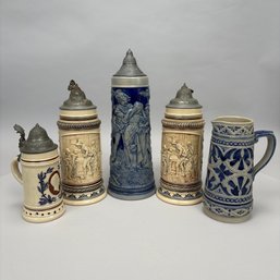 Four German Saltglaze Stoneware Steins  With Pewter Lids And A Pitcher, Late 19th-20th Century
