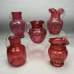 Five Cranberry Glass Pitchers